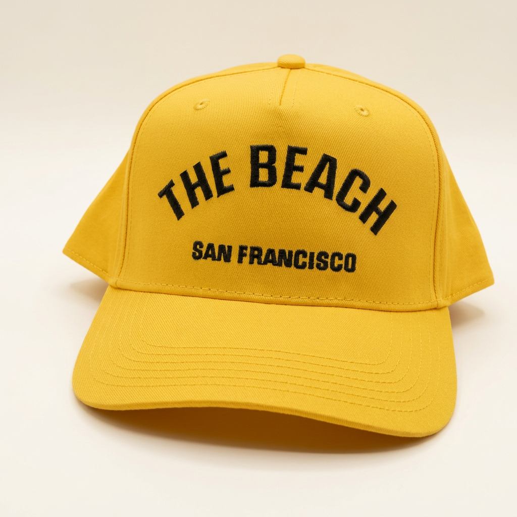 The Beach SF gold yellow hat on an off-white background