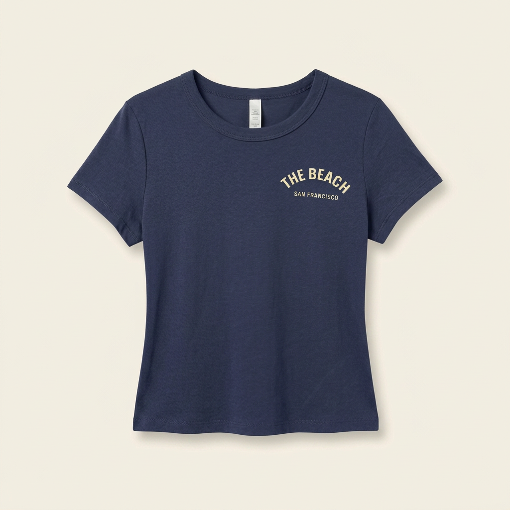 Navy women's tee with cream The Beach chest logo, front
