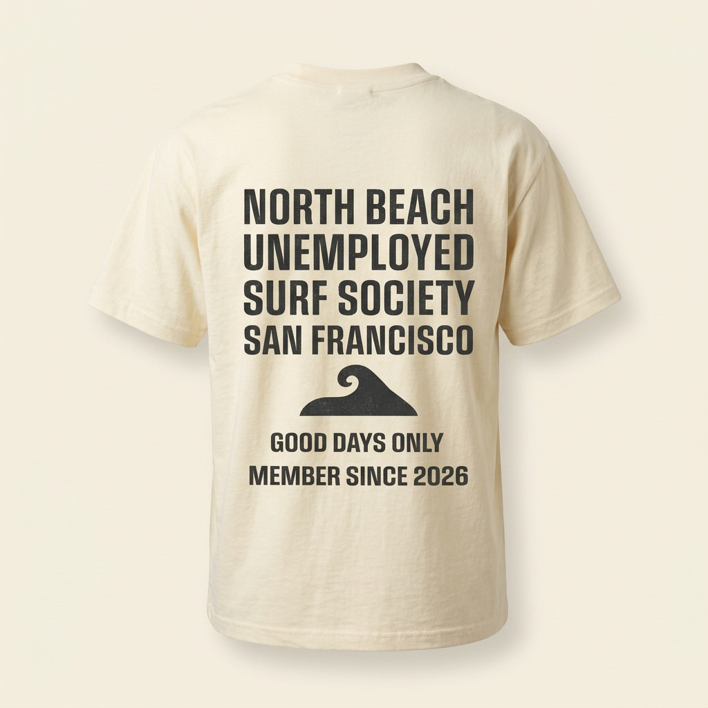Cream men's tee with dark North Beach Surf Society graphic, back
