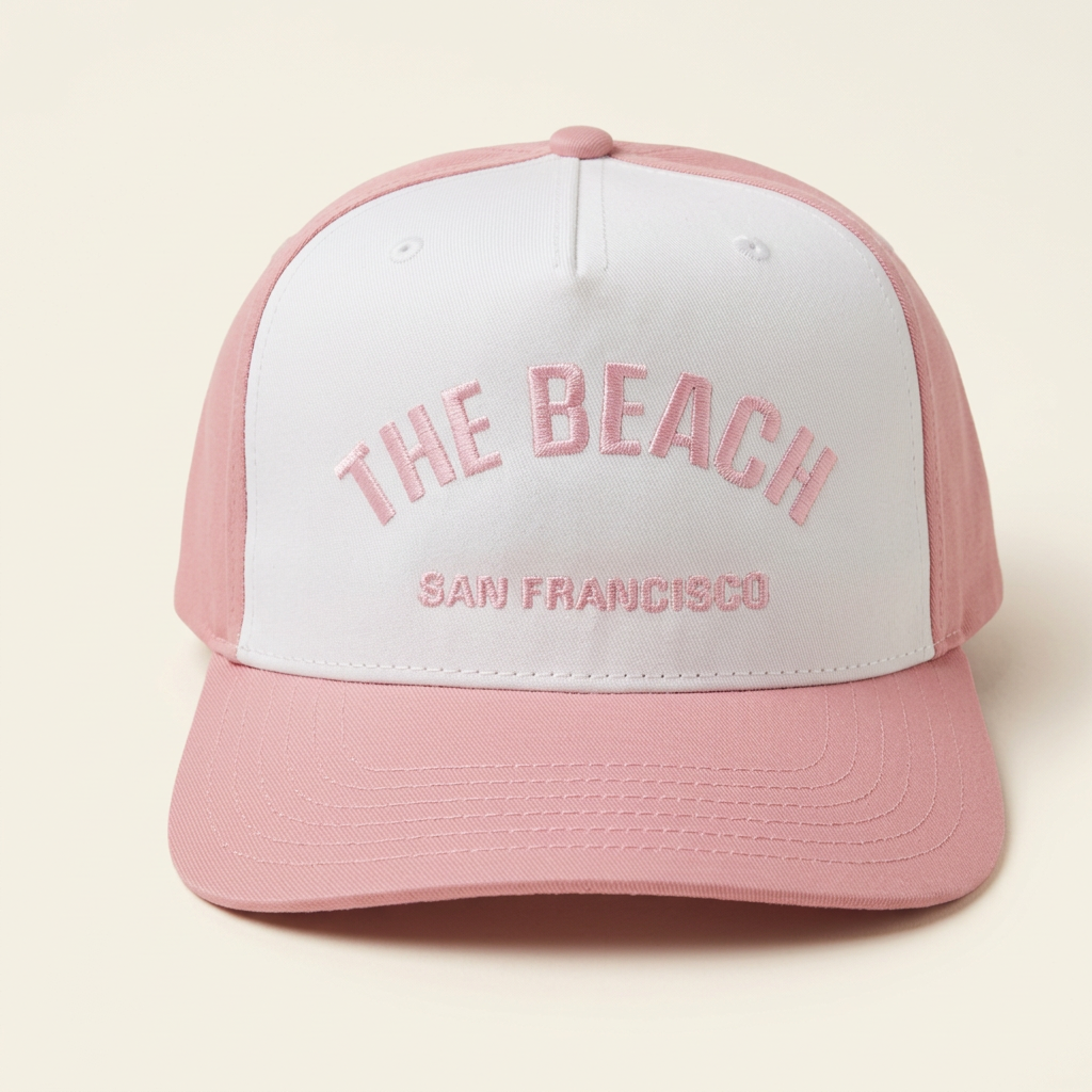 The Beach SF white and pink hat on an off-white background