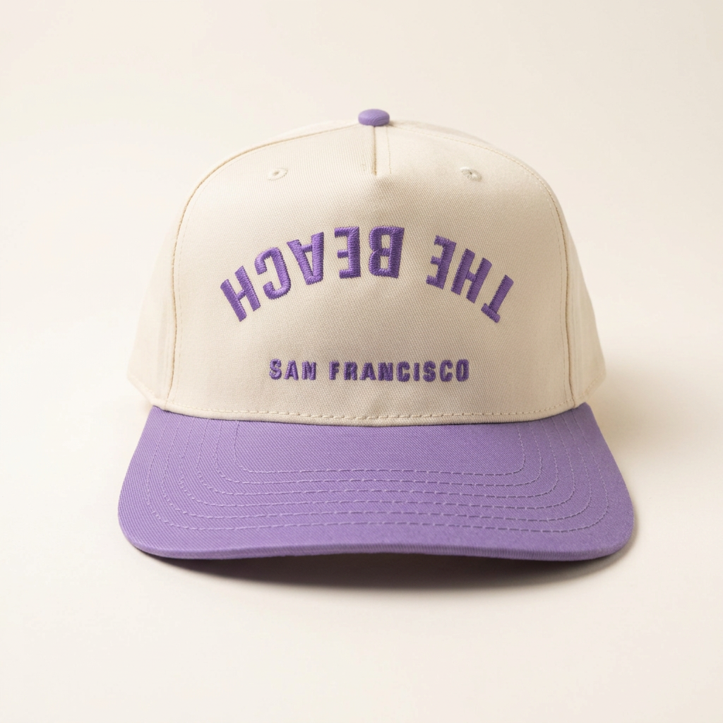 The Beach SF cream and purple Flip hat on an off-white background