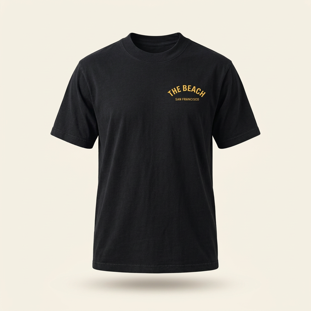 Black men's tee with yellow The Beach chest logo, front